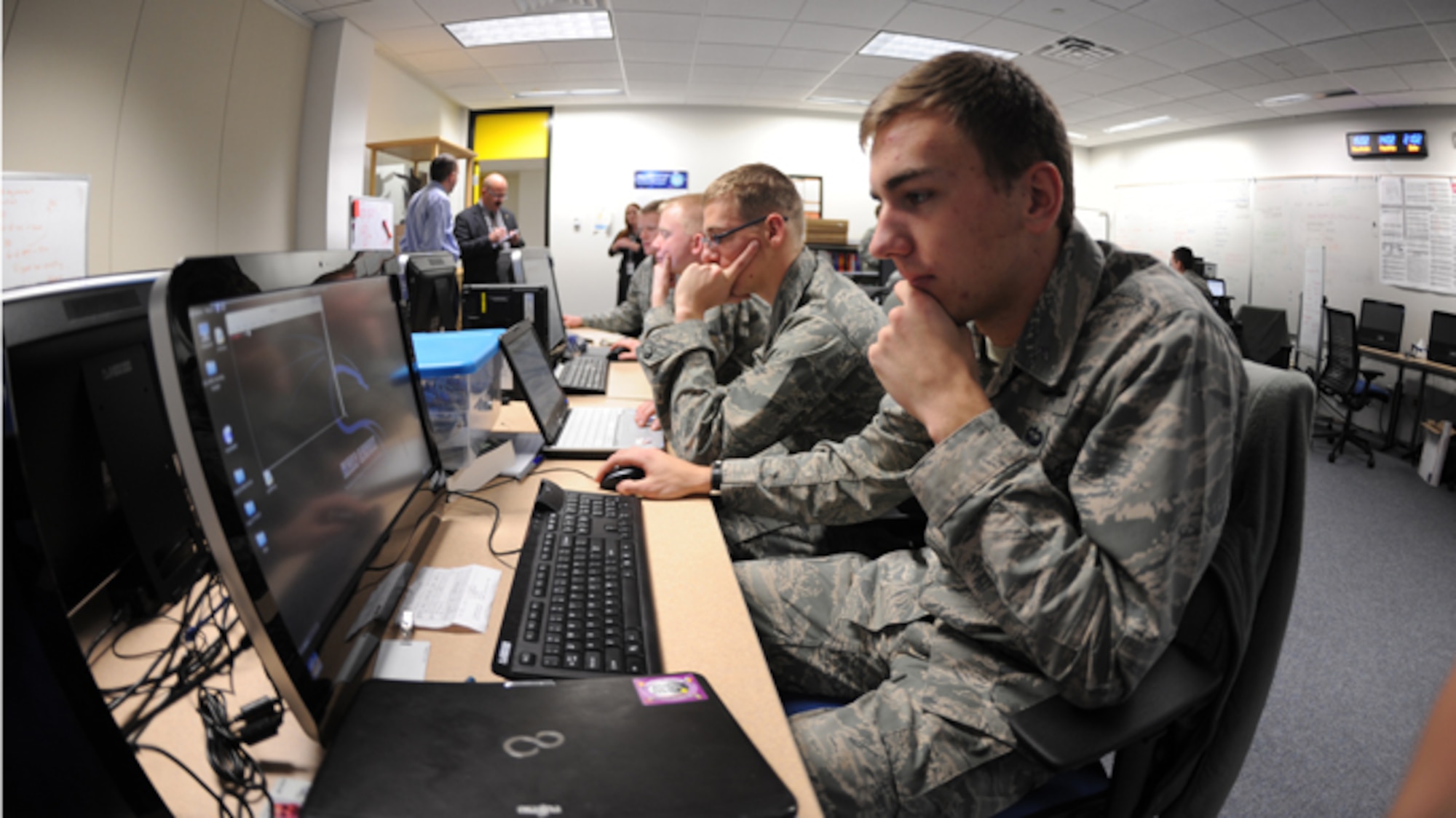 Members of the Academy Cyber Competition team run through scenarios in preparation for an upcoming competition Dec. 10, 2013, at the U.S. Air Force Academy, Colo. The team took second place at the conclusion of the 14th annual National Security Administration inter-service Cyber Defense Exercise here April 8-11. (U.S. Air Force Photo/John Van Winkle) 