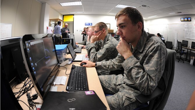 Members of the U.S. Air Force Academy Cyber Competition team run through scenarios in preparation for an upcoming competition Dec. 10, 2013, at the U.S. Air Force Academy, Colo. The team took second place at the conclusion of the 14th annual National Security Administration inter-service Cyber Defense Exercise here April 8-11. (U.S. Air Force Photo/John Van Winkle) 