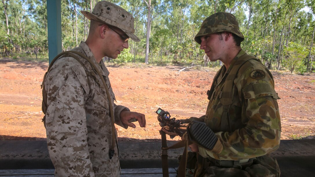 Lance Cpl. Richard Lewis, rifleman, 1st Battalion, 5th Marine Regiment, Marine Rotational Force – Darwin, shows a Soldier with the Australian Army how to fire their weapon systems aboard Robertson Barracks, April 15, 2014. The Australians fired the M4 carbine, the M16A4 Service Rifle and the M27 infantry automatic rifle. The Marines also instructed them on the proper use and care of the weapon systems.