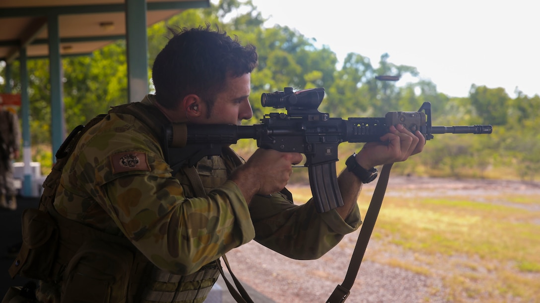 Capt. Christian Difabio, commanding officer of Logistics Company, 5th Battalion Royal Australian Regiment, fires the M4 Carbine aboard Robertson Barracks, April 15, 2014. The Australians fired the M4 carbine, the M16A4 Service Rifle and the M27 infantry automatic rifle. The Marines also instructed them on the proper use and care of the weapon systems.