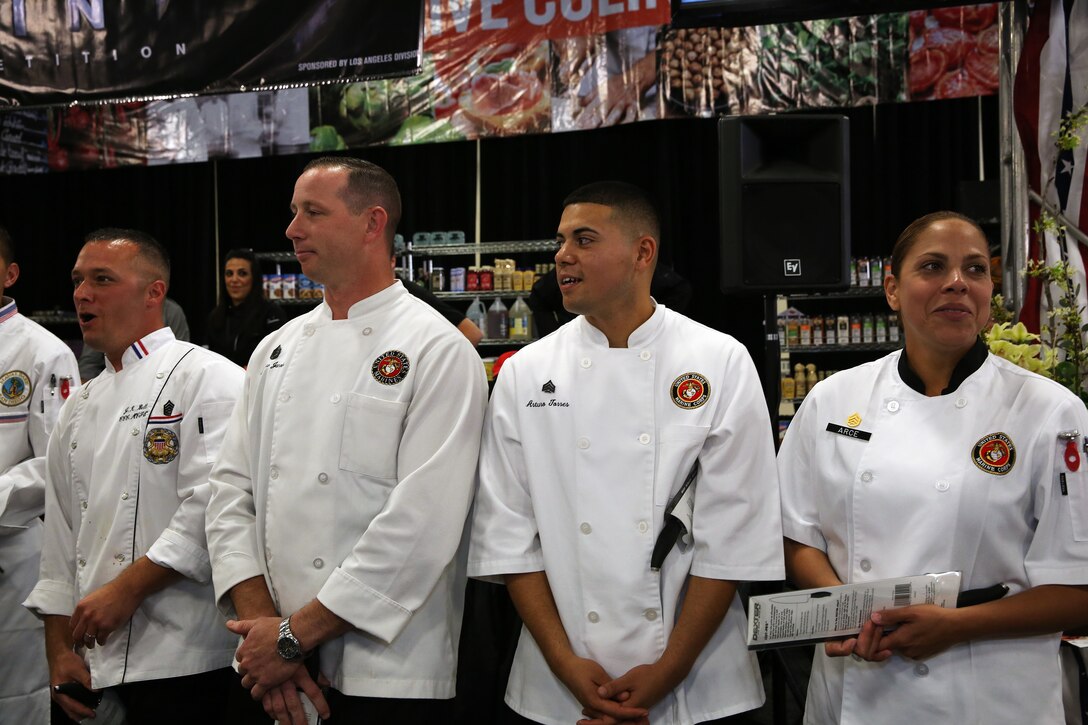 Chefs from the Marine Corps Installations West region wait for the winners to be announced at the Boiling Points competition held at the Del Mar Fairgrounds April 16. Boiling Points is a competition hosted by Aaron Williams, the corporate division chef for Food Fanatics, Los Angeles. The competition challenged the Marine Corps, Army, Navy and Coast Guard to go head-to-head in a 45-minute cooking competition. The Marine team took 1st place with their dish of an appetizer of fried eggplant and seared scallop caprese, and an entrée of seared duck, sweet potatoes and a fruit medley with a star fruit and horn melon sauce.