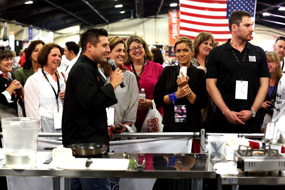 Spectators watch the teams compete at the Boiling Points competition held at the Del Mar Fairgrounds April 16. Boiling Points is a competition hosted by Aaron Williams, which challenged the Marine Corps, Army, Navy and Coast Guard to go head-to-head in a 45-minute cooking competition. The Marine team took 1st place with their dish of an appetizer of fried eggplant and seared scallop caprese, and an entrée of seared duck, sweet potatoes and a fruit medley with a star fruit and horn melon sauce.