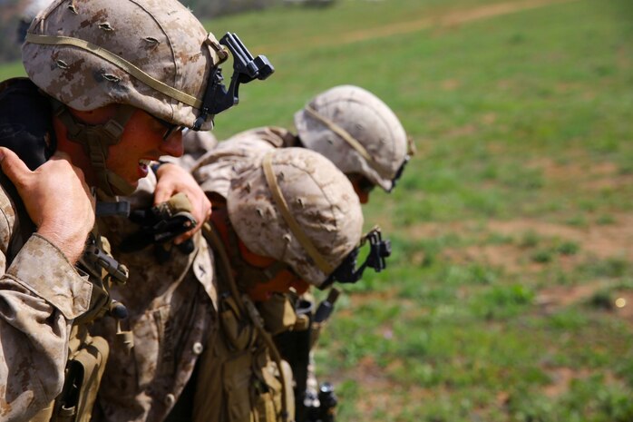Marines with 1st Battalion, 1st Marine Regiment, patrol during a squad tactics exercises aboard Marine Corps Base Camp Pendleton, Calif., April 9, 2014. The exercise gave assualtmen, mortarmen and machine-gunners an opportunity to coordinate with each other while assaulting through enemy positions during a large-scale raid. 1st Bn., 1st Marines, conducted this training in preparation for their upcoming deployment to Okinawa, Japan.