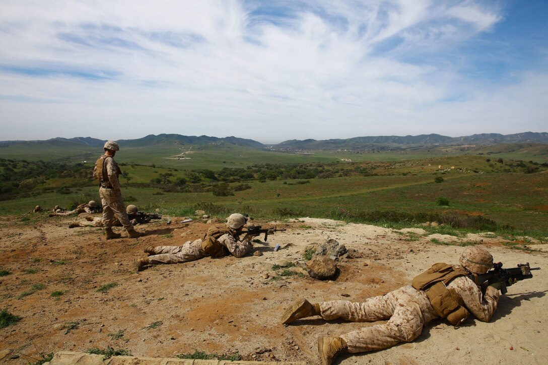 Marines with 1st Battalion, 1st Marine Regiment, patrol during a squad tactics exercises aboard Marine Corps Base Camp Pendleton, Calif., April 9, 2014. The exercise gave assualtmen, mortarmen and machine-gunners an opportunity to coordinate with each other while assaulting through enemy positions during a large-scale raid. 1st Bn., 1st Marines, conducted this training in preparation for their upcoming deployment to Okinawa, Japan.