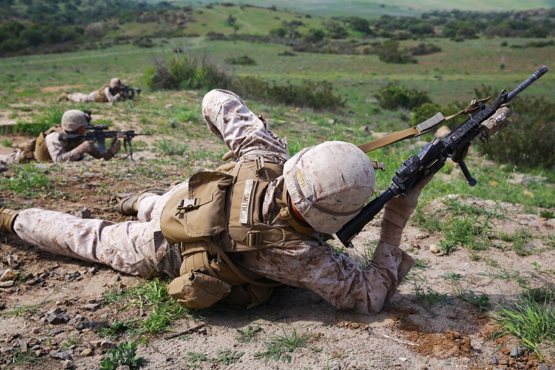 Marines with 1st Battalion, 1st Marine Regiment, patrol during a squad tactics exercises aboard Marine Corps Base Camp Pendleton, Calif., April 9, 2014. The exercise gave assualtmen, mortarmen and machine-gunners an opportunity to coordinate with each other while assaulting through enemy positions during a large-scale raid. 1st Bn., 1st Marines, conducted this training in preparation for their upcoming deployment to Okinawa, Japan.