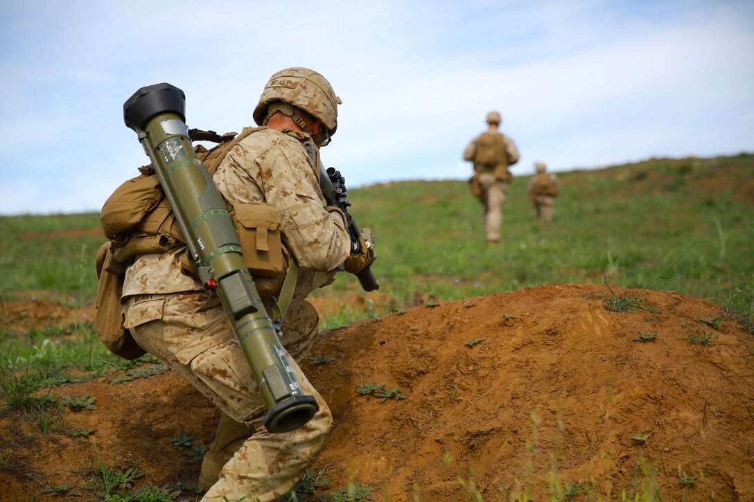 Marines with 1st Battalion, 1st Marine Regiment, patrol during a squad tactics exercises aboard Marine Corps Base Camp Pendleton, Calif., April 9, 2014. The exercise gave assualtmen, mortarmen and machine-gunners an opportunity to coordinate with each other while assaulting through enemy positions during a large-scale raid. 1st Bn., 1st Marines, conducted this training in preparation for their upcoming deployment to Okinawa, Japan.