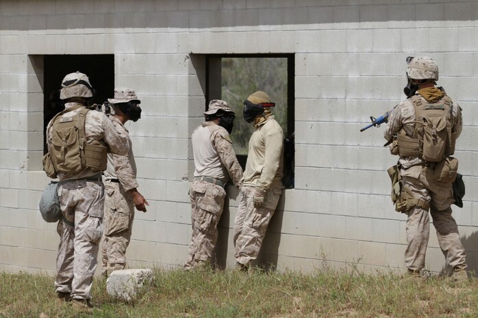 Marines with 1st Battalion, 1st Marine Regiment, patrol during a squad tactics exercises aboard Marine Corps Base Camp Pendleton, Calif., April 9, 2014. The exercise gave assualtmen, mortarmen and machine-gunners an opportunity to coordinate with each other while assaulting through enemy positions during a large-scale raid. 1st Bn., 1st Marines, conducted this training in preparation for their upcoming deployment to Okinawa, Japan.