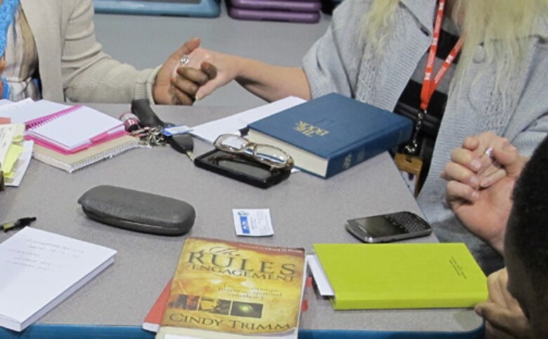 Huntsville Center's  Bible Study Fellowship members form a prayer circle during Bible Study/Fellowship April 16.                             