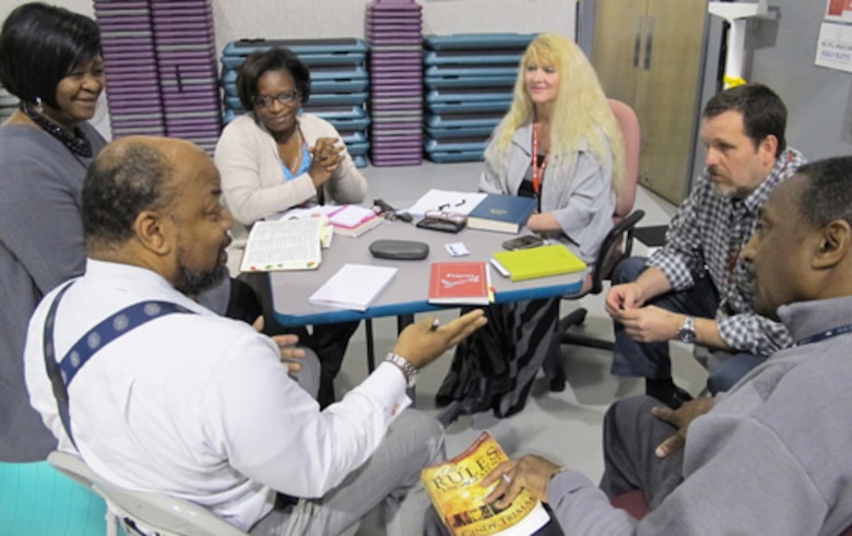 From left, Willie Wade, Virgil Green, Willie Stokes, Rex McLaury, Cheryl Renz-Olar and Barbara Tolliver;  Corps of Engineers,  Huntsville Center, share their faith during a group Bible Study/Fellowship at the organization April 16.                           