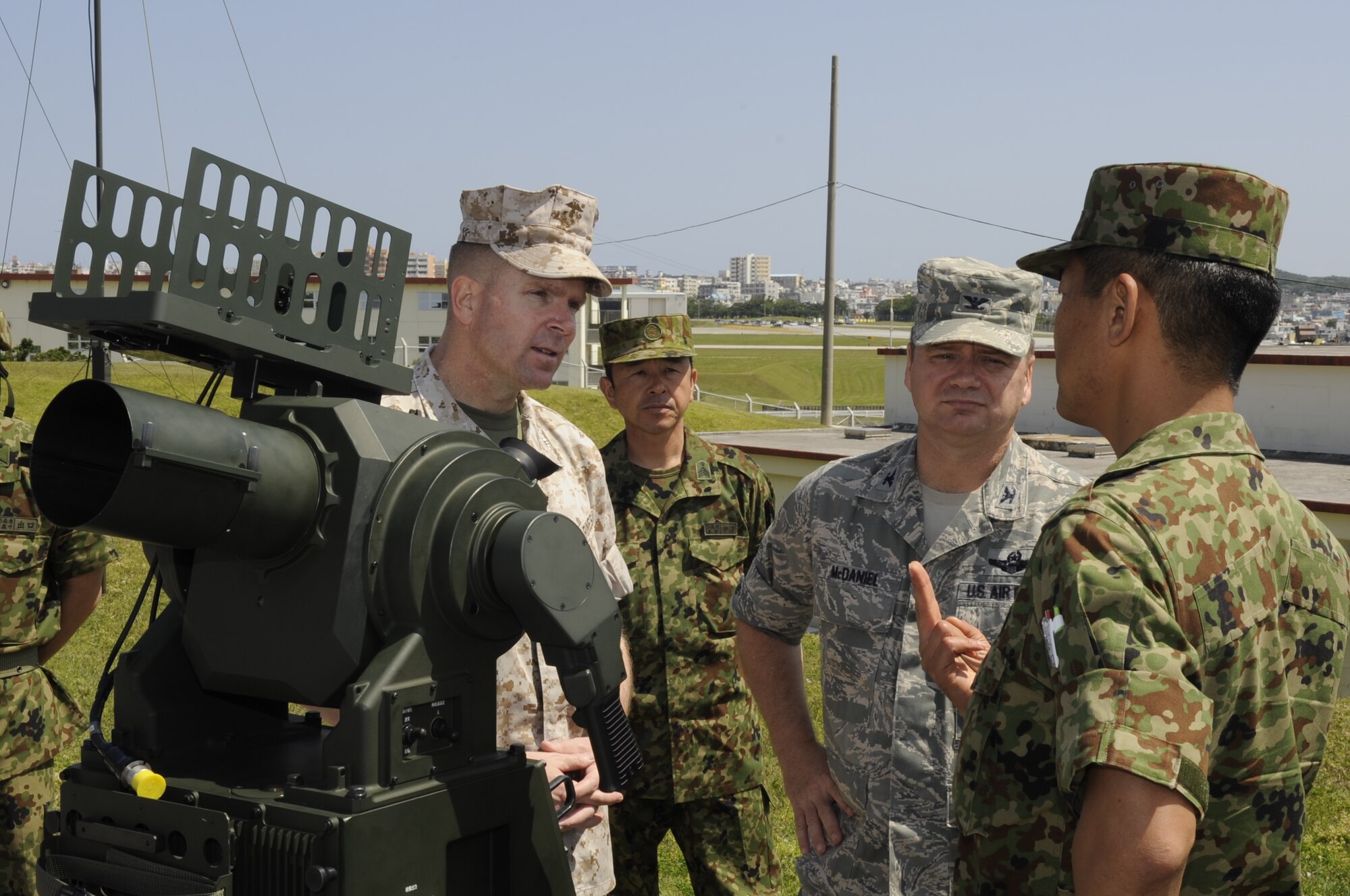U.S. Marine Corps Col. Scott Stebbins, Marine Air Control Group 18 commander, and U.S. Air Force Col. Brian McDaniel, 18th Wing vice commander, get briefed on the air defense capabilities of the Japan Ground Self-Defense Force on Marine Corps Air Station Futenma, Japan, April 15, 2014. The demonstration allowed military members with similar jobs to observe the differences between their mission objectives and their JGSDF counterparts. (U.S. Air Force photo by Senior Airman Marcus Morris)