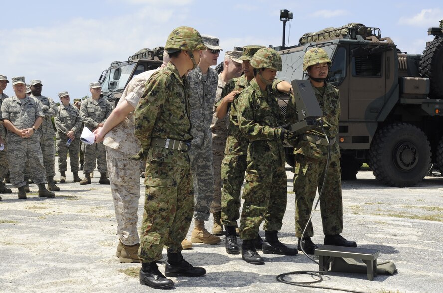 Japan Ground Self-Defense Force  members demonstrate loading a launcher unit to U.S. military members on Marine Corps Air Station Futenma, Japan, April 15, 2014. The demonstration allowed military members with similar jobs to observe the differences between their mission objectives and their JGSDF counterparts. (U.S. Air Force photo by Senior Airman Marcus Morris)
