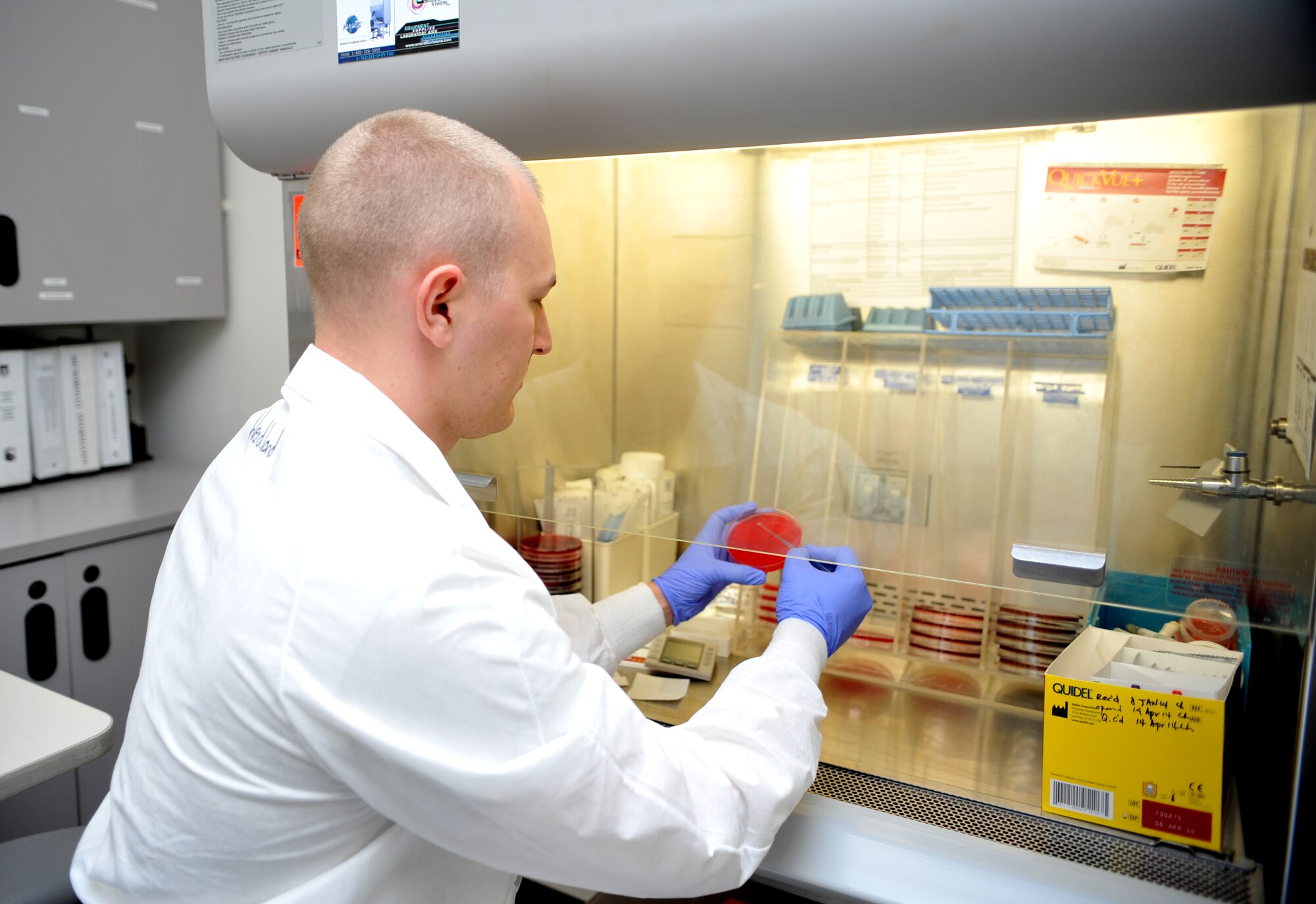 Staff Sgt. Grant Wendland, 51st Medical Support Squadron medical laboratory technician, streaks out a streptococcal pharyngitis, or strep throat, culture plate as part of a rapid strep test in the 51st Medical Group at Osan Air Base, Republic of Korea, April 17, 2014. When rapid strep tests show a negative result, technicians perform this secondary check for isolation to confirm the original result. (U.S. Air Force photo/Airman 1st Class Ashley J. Thum) 