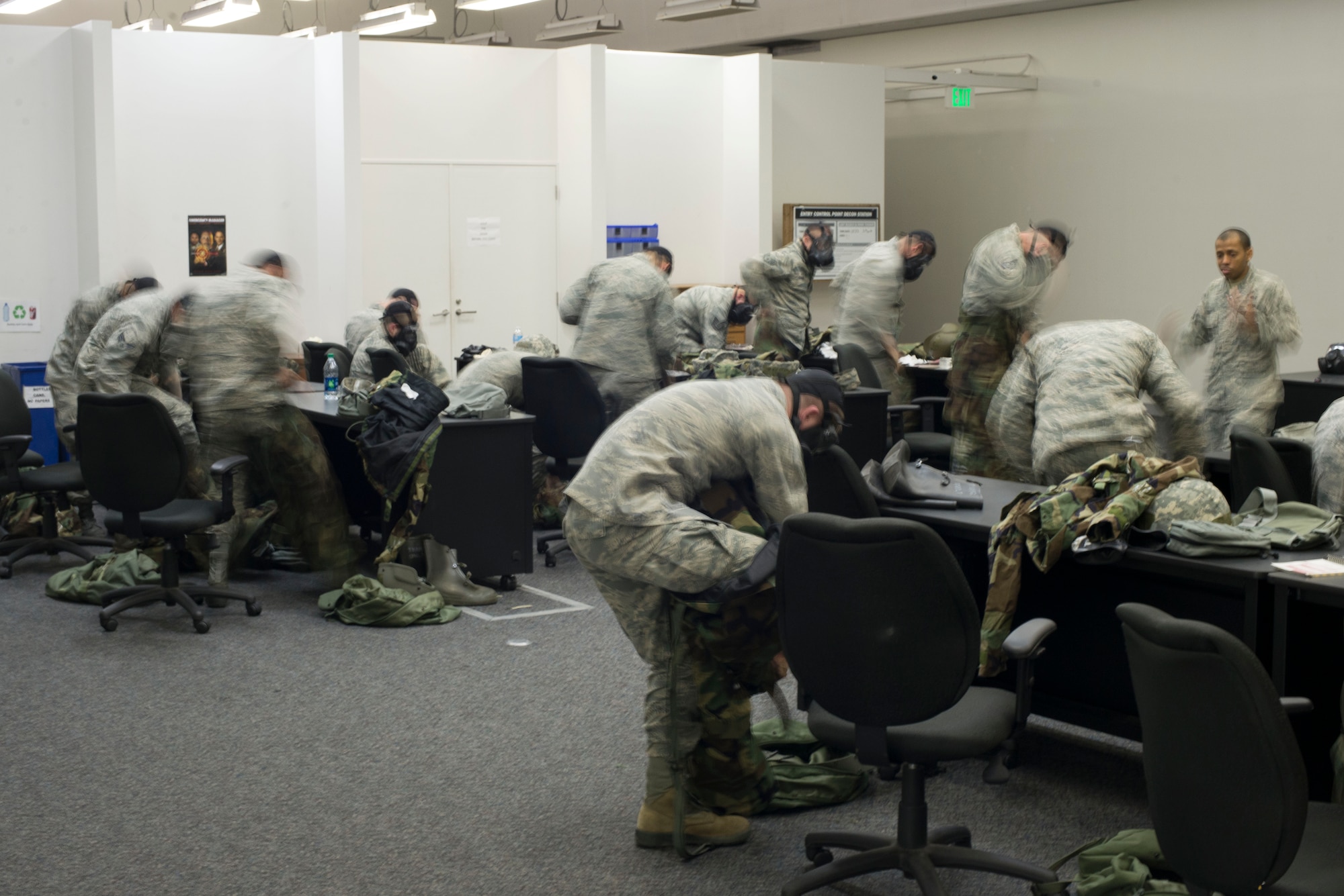 Airmen are timed while donning mission-oriented protective posture 4 during chemical, biological, radiological and nuclear defense training April. 17, 2014 at Yokota Air Base, Japan. The training was held to reacquaint Airmen with basic contingency skills. (U.S. Air Force photo by Staff Sgt. Chad C. Strohmeyer/Released)