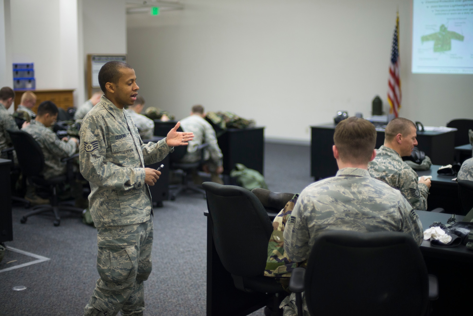 Staff Sgt. Sheraz Cedeno, 374th Civil Engineer Squadron, quizzes Airmen during chemical, biological, radiological and nuclear defense training April. 17, 2014 at Yokota Air Base, Japan. (U.S. Air Force photo by Staff Sgt. Chad C. Strohmeyer/Released)
