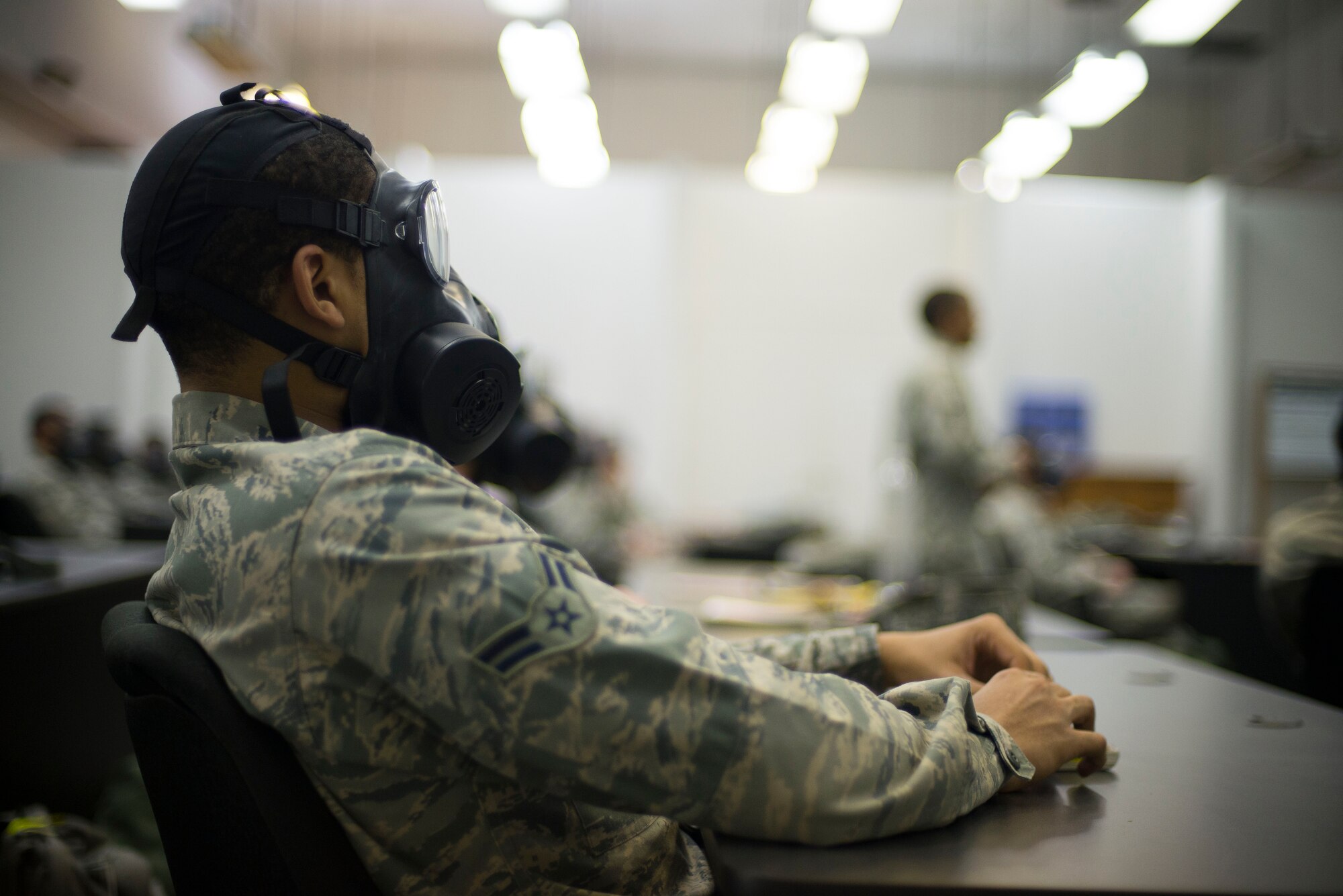 An Airmen sits in his M50 gas mask during chemical, biological, radiological and nuclear defense training April. 17, 2014 at Yokota Air Base, Japan. The purpose of the CBRN training is for Airmen to hone their skills to operate in chemical or biological environments during wartime. (U.S. Air Force photo by Staff Sgt. Chad C. Strohmeyer/Released)