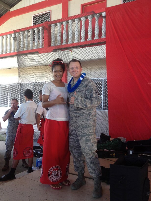 American Samoa-- SSgt Troy Griffin poses with one of the students from Samoana High School after "Small Kine" performed for the school on March 26, 2014. (US Air Force Photo/Michael Smith/ Released) 
