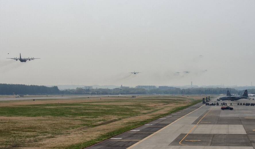 A formation of U.S. Air Force C-130 Hercules fly over Yokota Air Base, Japan, April 16, 2014. Six Yokota C-130s participated in regional operations to practice their large formation airlift tactics and procedures. (U.S. Air Force photo by Osakabe Yasuo/Released)