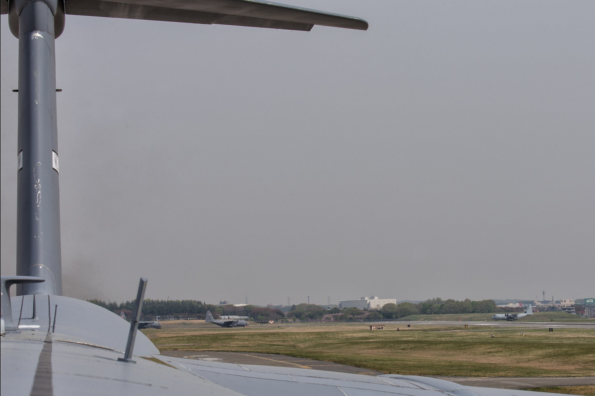 (Left to right) C-130 Hercules from the 36th Airlift Squadron and a KC-130J Super Hercules from Marine Corps Air Station Futenma prepare to take off at Yokota Air Base, Japan, April 16, 2014. The aircraft were involved in supporting regional training operations to test Yokota’s ability to perform large force employment and tactics. (U.S. Air Force photo by Osakabe Yasuo/Released)