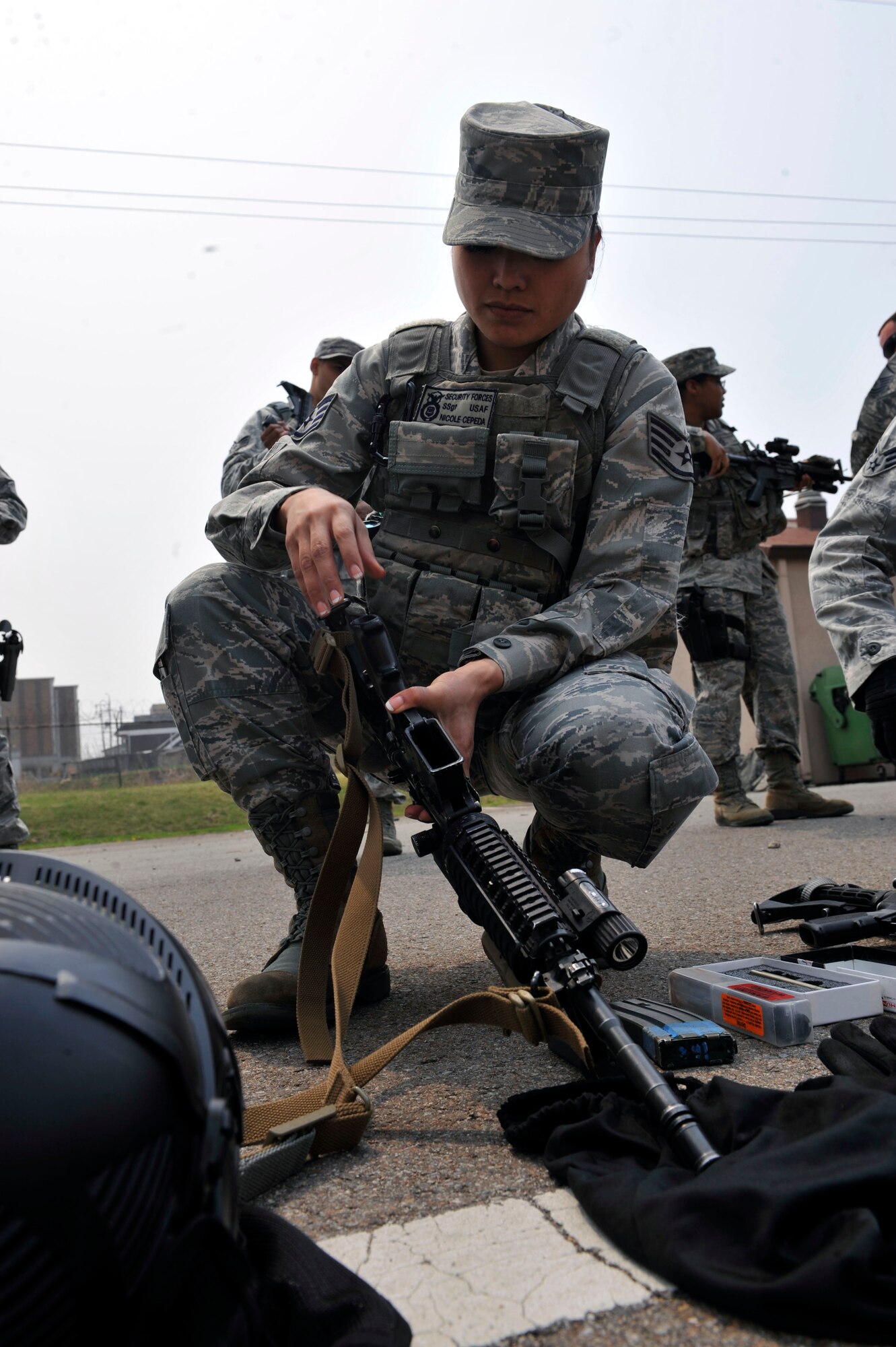 Staff Sgt. Nicole Cepeda, 51st Security Forces Squadron patrolman, puts her M4 assault rifle together after changing the bolt inside the receiver to shoot the dye-marked simulated munitions at the Rush Park and Life Support site at Osan Air Base, Republic of Korea, April 15, 2014. SFS members also went through mounted and dismounted operations training, weapon and radio familiarization and force-on-force training. (U.S. Air Force photo by Senior Airman David Owsianka)