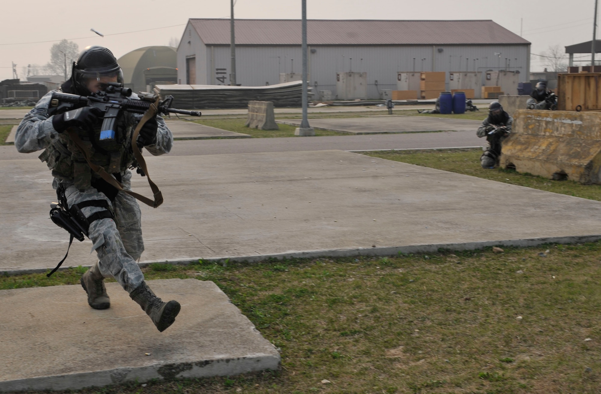 Senior Airman Francisco Maciel, 51st Security Forces Squadron area supervisor, advances towards opposing forces during the force-on-force training scenario at the Rush Park and Life Support site at Osan Air Base, Republic of Korea, April 15, 2014. The objective of this training was to rescue a downed defender. (U.S. Air Force photo by Senior Airman David Owsianka)