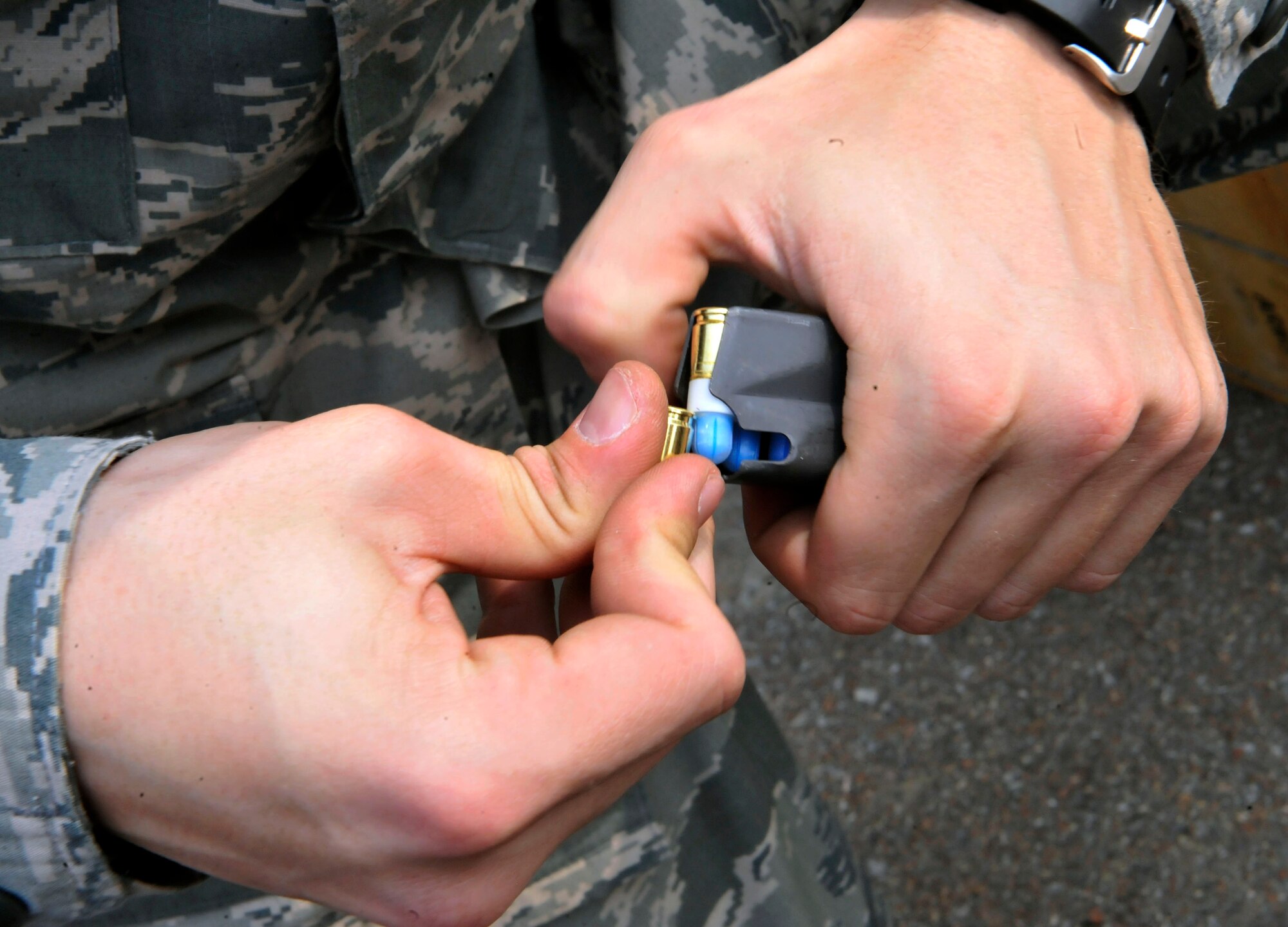 Airman 1st Class Tyler Zimmerman, 51st Security Forces Squadron entry controller, loads dye-marked simulated munitions into an M9 magazine at the Rush Park and Life Support site at Osan Air Base, Republic of Korea, April 15, 2014. The simulated munitions were used during the building clearing and close quarters battling scenarios. (U.S. Air Force photo by Senior Airman David Owsianka)