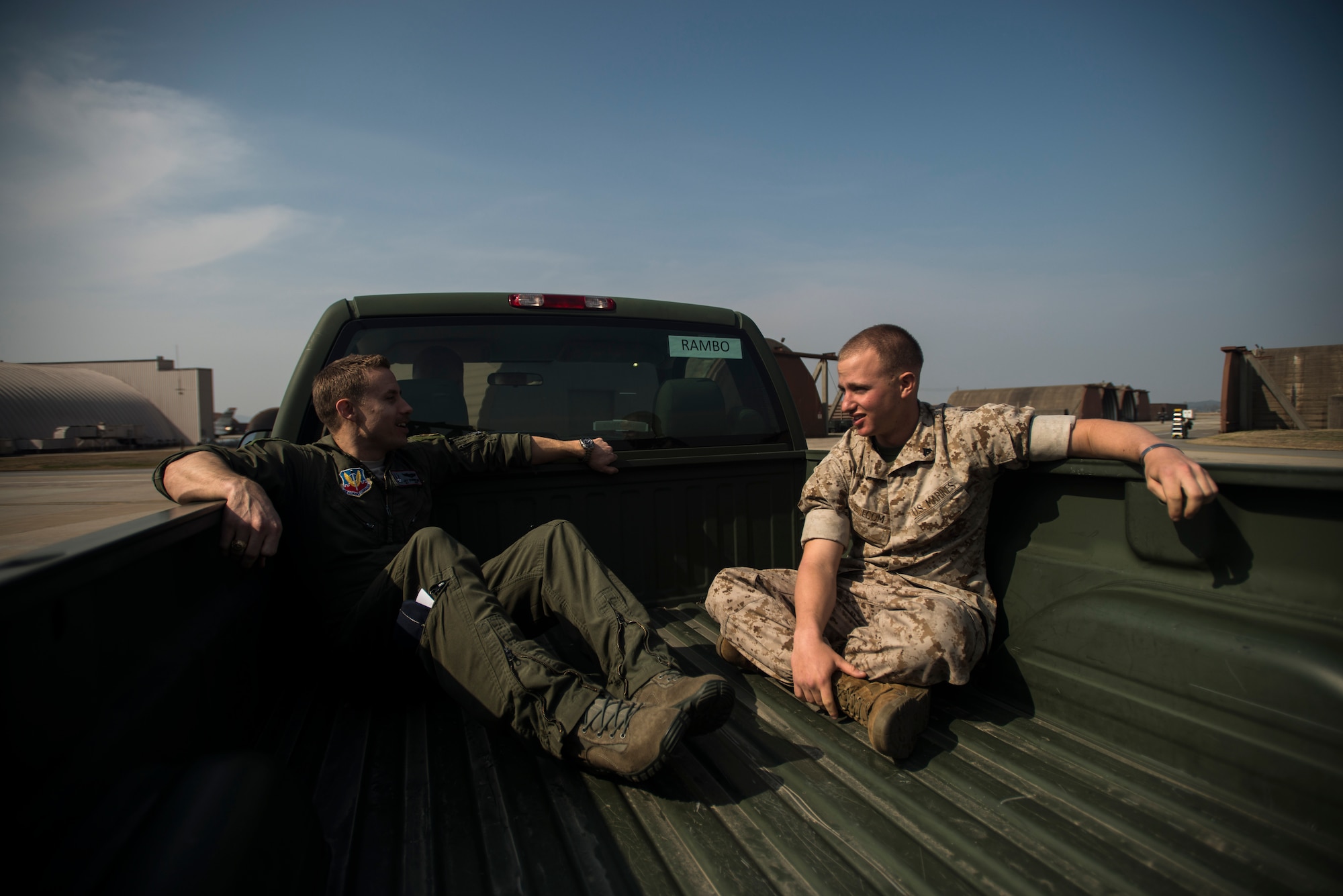 Marine Corps Cpl. Jake Balcom talks to Capt. Jay Doerfler, 421st Fighter Squadron chief of training, while touring the 421st FS March 26, 2014, at Osan Air Base, Republic of Korea. Balcom's grandfather, Col. Ralph Balcom, served with the 421st during Vietnam before being declared missing in action. (U.S. Air Force photo by Staff Sgt. Jake Barreiro)