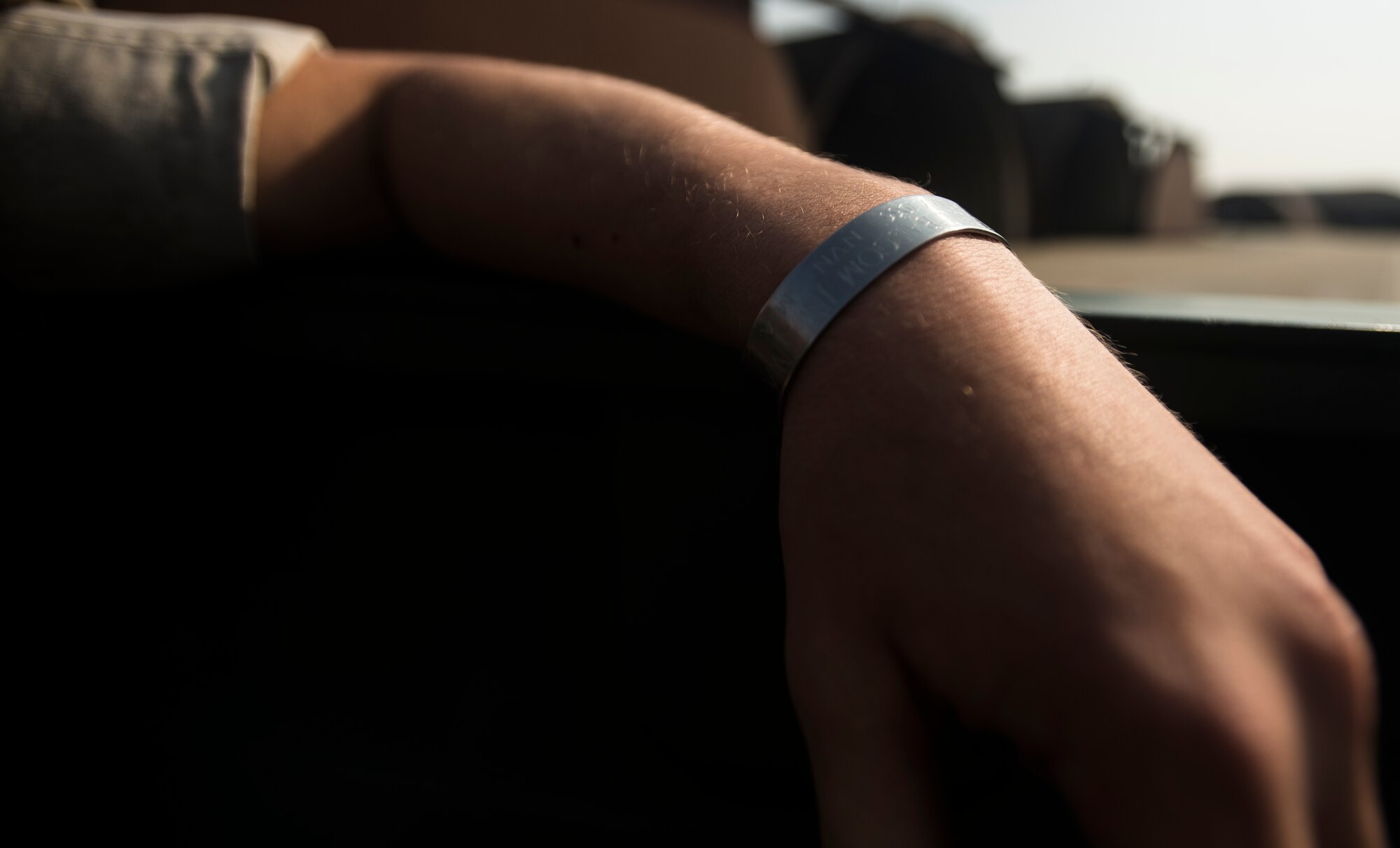 Marine Corps Cpl. Jake Balcom wears a POW/MIA bracelet with his grandfather's name on it March 26, 2014, at Osan Air Base, Republic of Korea. Balcom's grandfather, Col. Ralph Balcom, served as a fighter pilot in Vietnam and has been missing since May 15, 1966. (U.S. Air Force photo by Staff Sgt. Jake Barreiro)