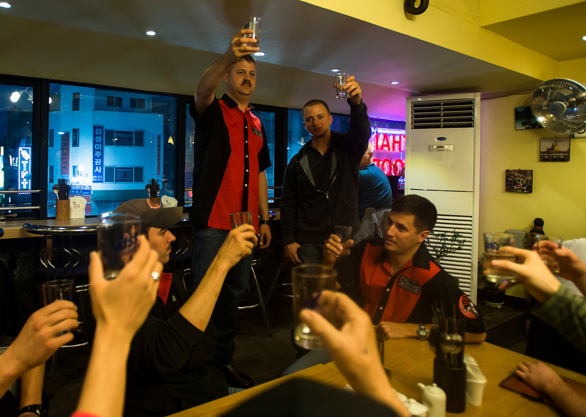 Lt. Col. David Shoemaker, 421st Fighter Squadron commander, Marine Corps Cpl. Jake Balcom, and other members of the 421st FS raise their glasses in a toast to Col. Ralph Balcom, a fallen Vietnam War pilot, March 26, 2014, in Pyeongtaek, Republic of Korea. Shoemaker and the 421st toast to Ralph Balcom's name every six weeks as an appreciation for their heritage and a reminder of the families effected by sacrifice. (U.S. Air Force photo by Staff Sgt. Jake Barreiro)