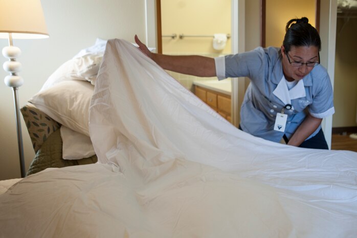 Lynn Rose, 30th Force Support Squadron Lodging custodial worker, makes a bed during her shift April 9, 2014, Vandenberg Air Force Base, Calif. The housekeeping team has earned 90 to 100 percent guest satisfaction from comment cards and online surveys. (U.S. Air Force photo/Airman 1st Class Yvonne Morales)