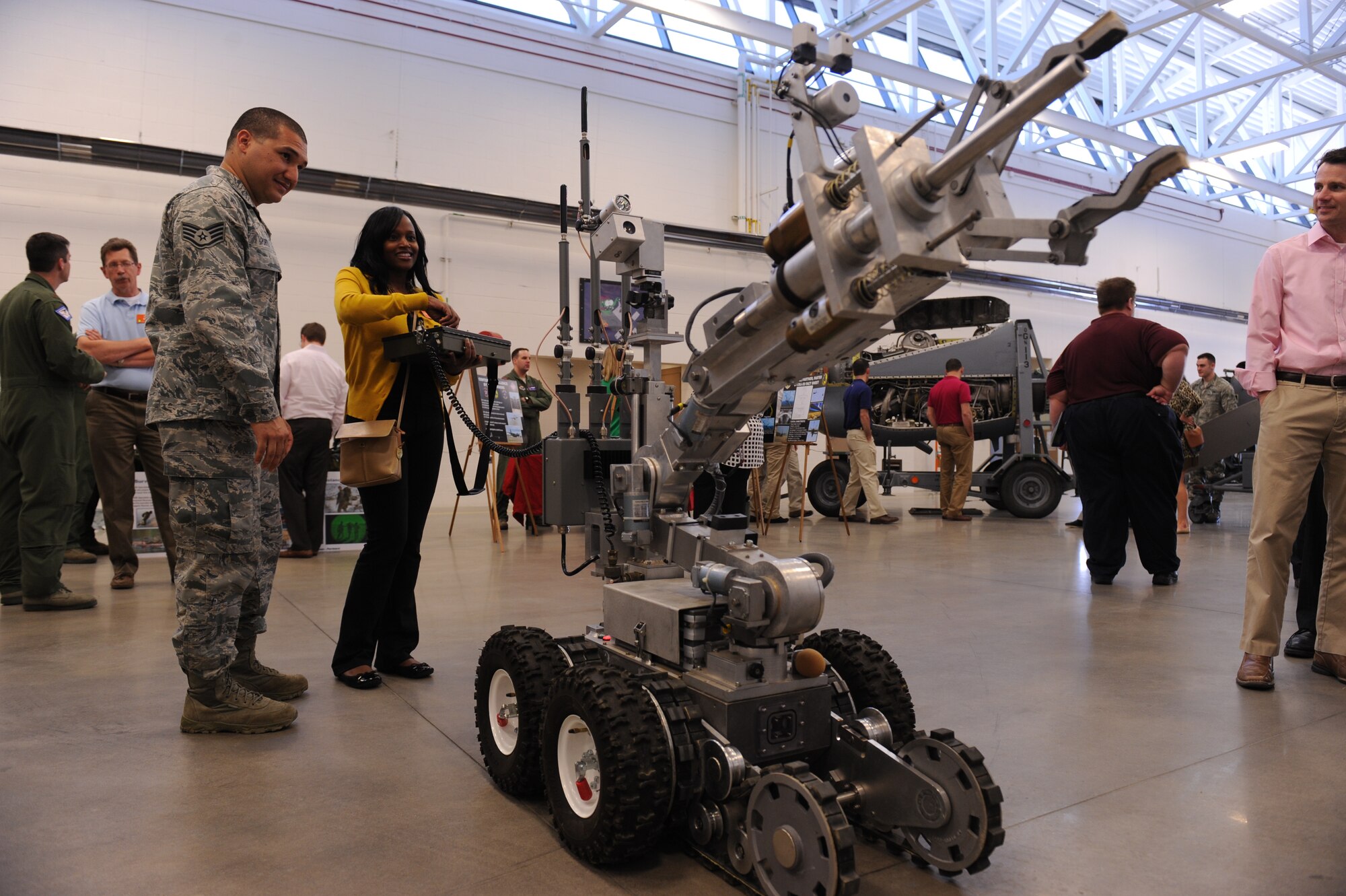 An Airman from the 19th Civil Engineer Squadron explosive ordinance disposal teaches a member of the Leadership Greater Little Rock Tour how to use the reconnaissance and disposal robot April 10, 2014, at Little Rock Air Force Base, Ark. Each year approximately 50 class members are selected from hundreds of applicants to participate in the nine-month program. (U.S. Air Force photo by Airman 1st Class Cliffton Dolezal)
