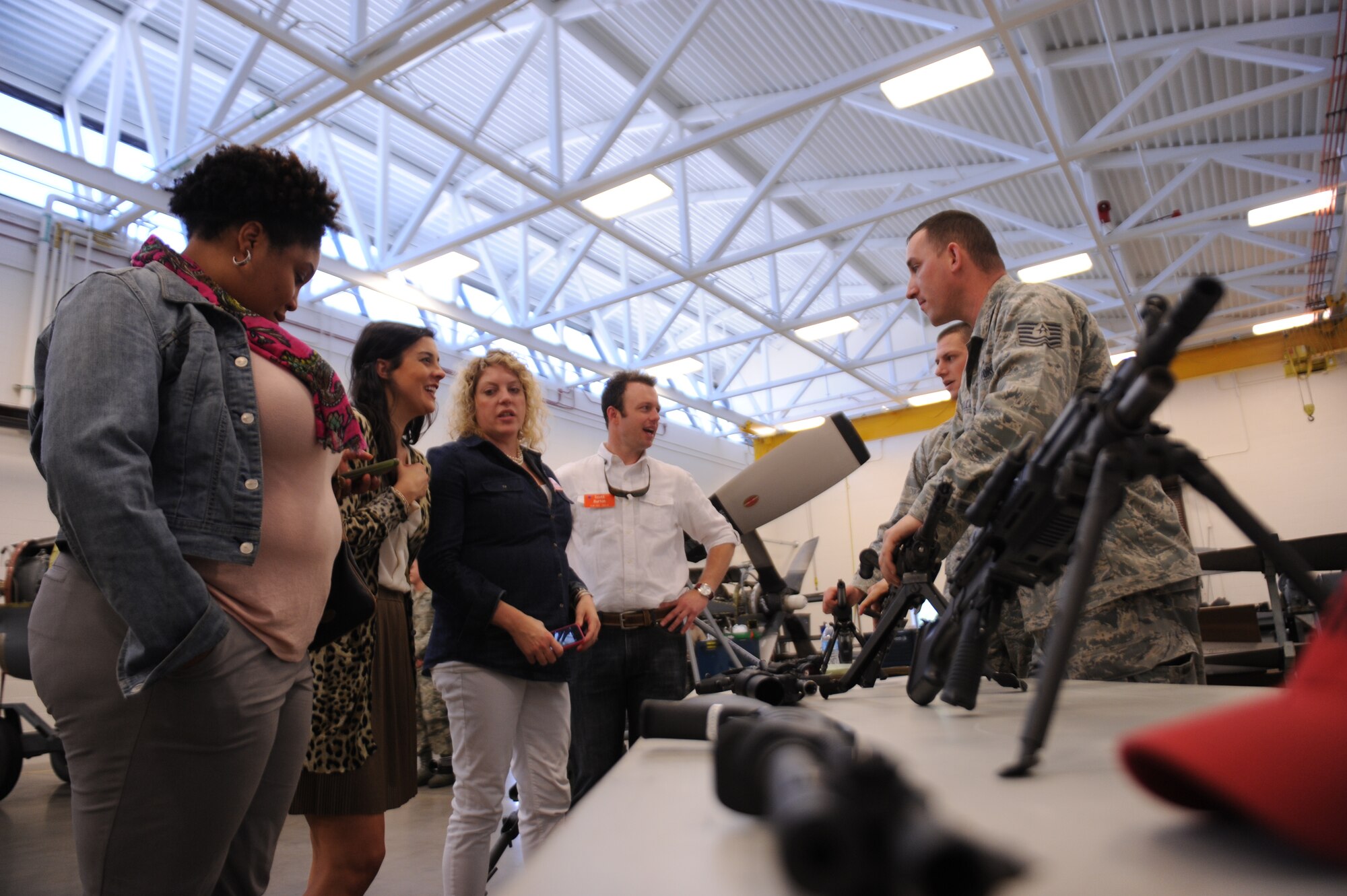 Members from the 19th Security Forces Squadron show members of the Leadership Greater Little Rock tour the weapons they train and work with April 10, 2014, at Little Rock Air Force Base, Ark. The tour consisted of booths set up by security forces, explosive ordinance disposal, survive evasion resistance and escape, aircraft maintenance, a tour of a C-130 as well as demonstrations put on by the fire department and K-9 unit. (U.S. Air Force photo by Airman 1st Class Cliffton Dolezal)