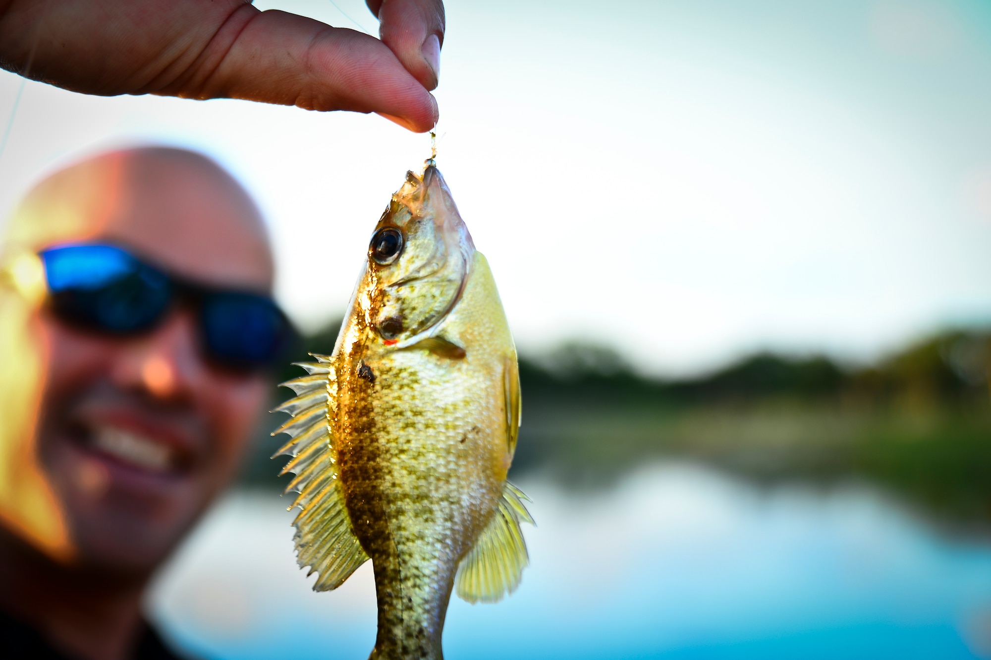 Petty Officer 1st Class Danny White, Project Healing Waters Fly Fishing instructor, displays a fish during a class held at MacDill Air Force Base, April 17, 2014. PHWFF is a no-cost program that consists of rotational fly tying, casting and rod building classes for disabled veterans. (U.S. Air Force photo by Staff Sgt. Brandon Shapiro/Released)