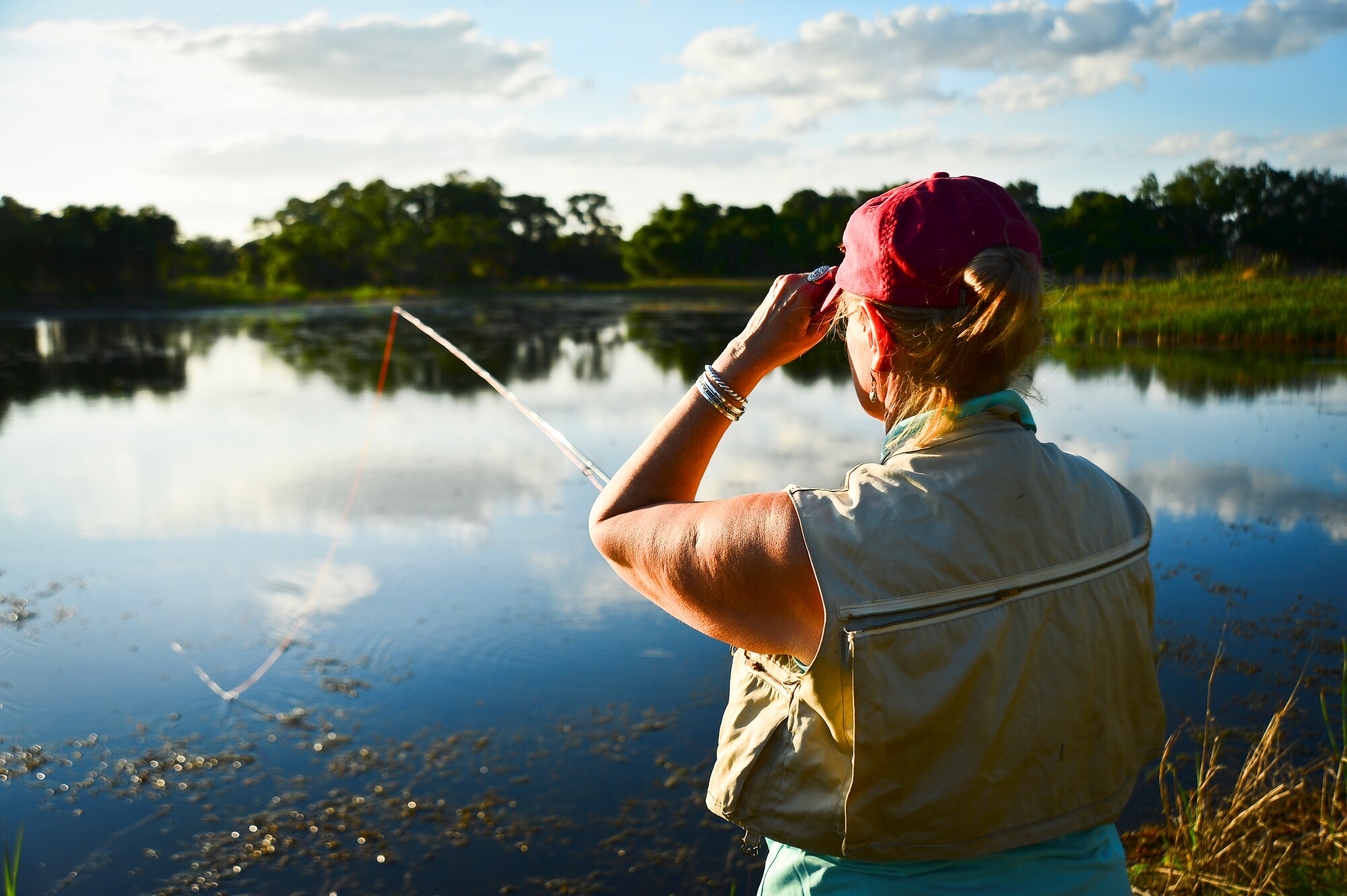 Deborah Brooks, Project Healing Waters Fly Fishing Tampa lead, demonstrates proper casting techniques during a class held at MacDill Air Force Base, April 17, 2014. Events like these are the backbone of the program; they give individuals the confidence to get out of their comfort zones and meet new people. With this, they are able to condition their mental and physical ailments in an environment that is relaxing and easy to enjoy from nearly anywhere. (U.S. Air Force photo by Staff Sgt. Brandon Shapiro/Released)