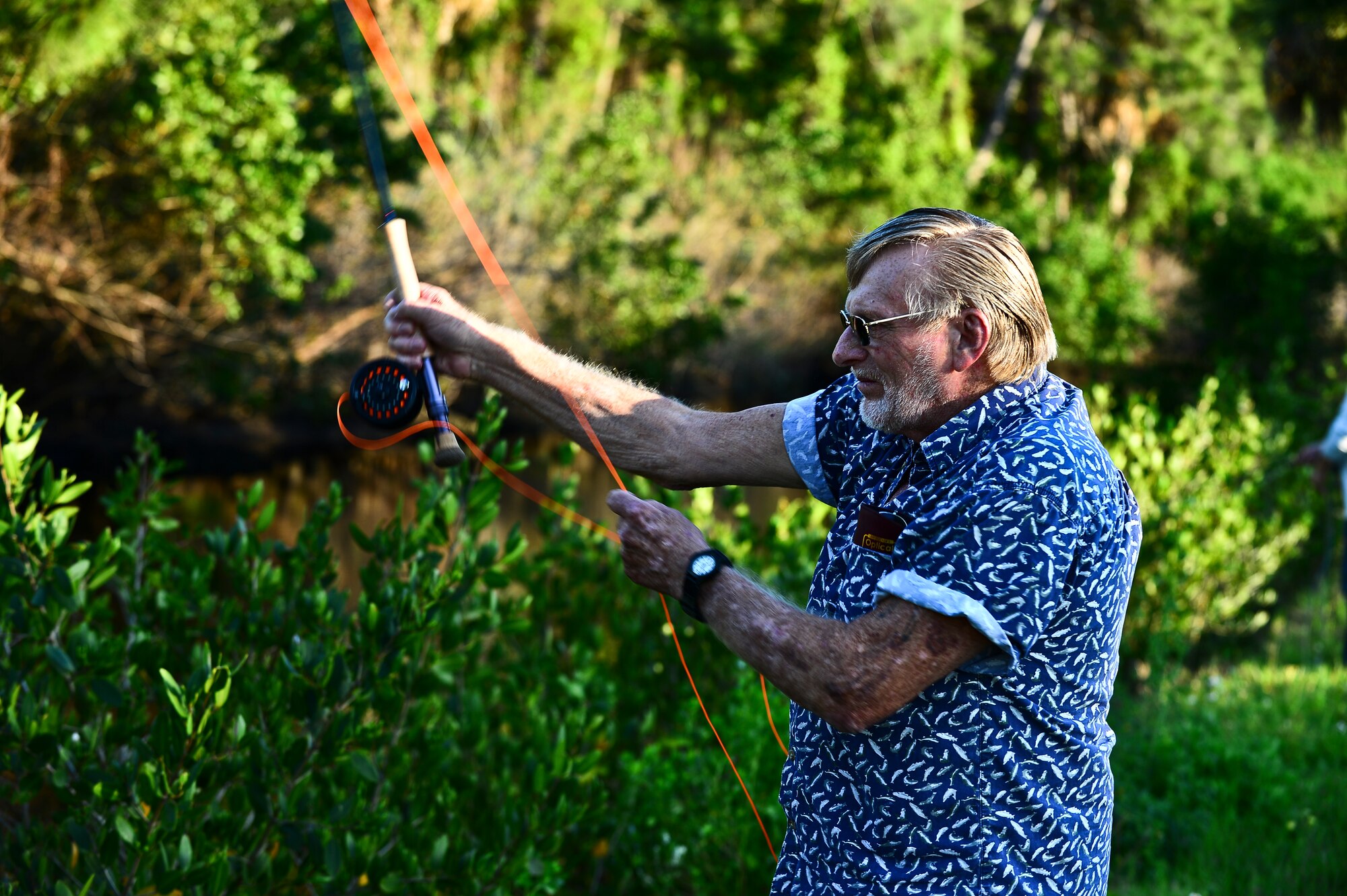 Stan Green, a Project Healing Waters Fly Fishing participant, practices casting during a class held at MacDill Air Force Base, April 17, 2014. Green is a Vietnam-era Navy veteran. (U.S. Air Force photo by Staff Sgt. Brandon Shapiro/Released)