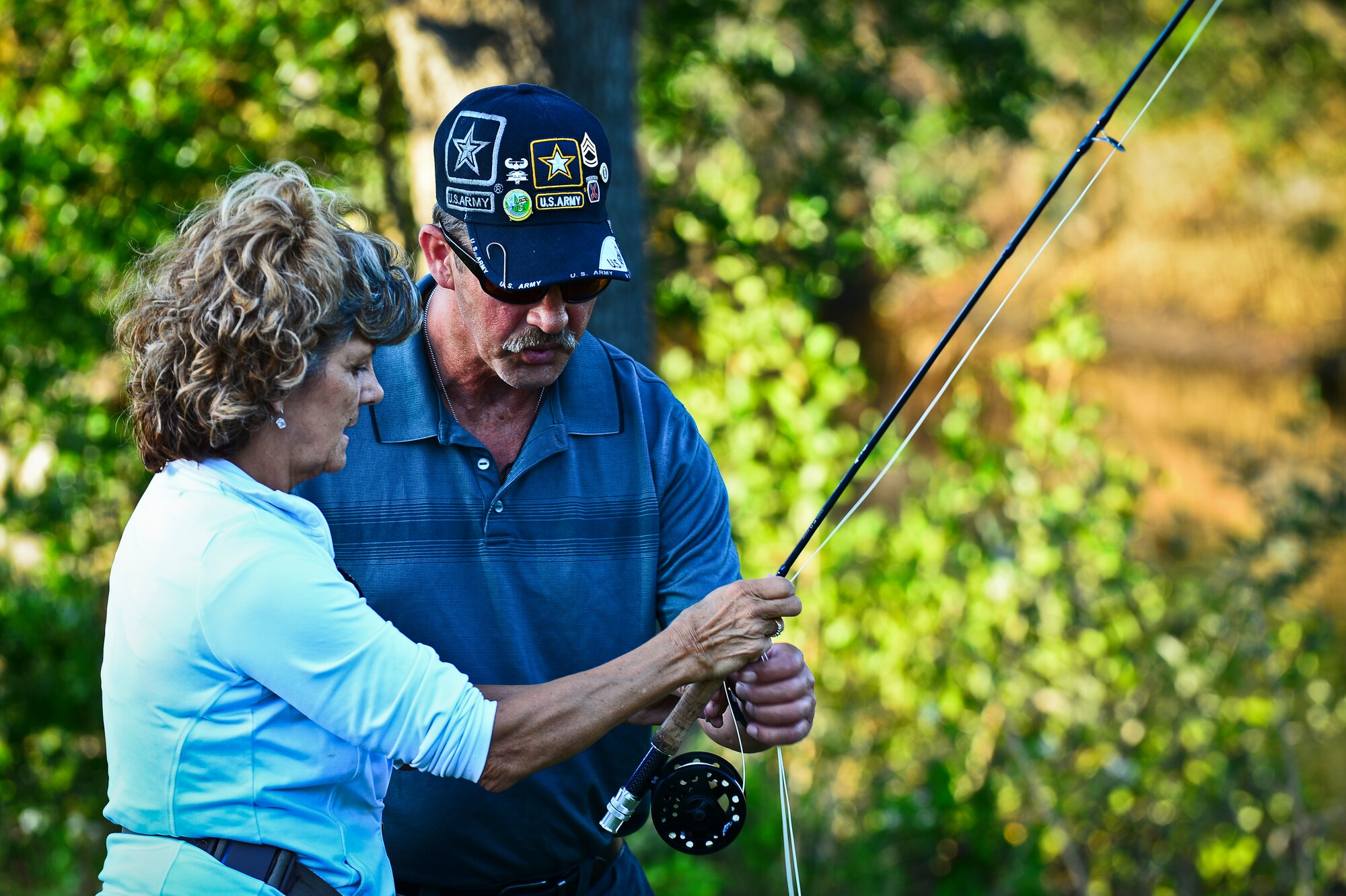 Deb and Harold Bell, Project Healing Waters Fly Fishing participants, ready their fly rod during class held at MacDill Air Force Base, April 17, 2014. PHWFF is dedicated to the physical and emotional rehabilitation of veterans through fly fishing and associated activities, including education and outings. (U.S. Air Force photo by Staff Sgt. Brandon Shapiro/Released)