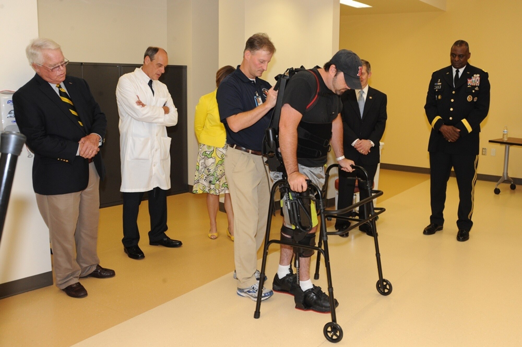Army veteran and patient Josh Baker uses a therapeutic exoskeleton to assist him in walking during an open house at the James A. Haley Veterans’ Hospital, Apr. 12, 2014. Baker was paralyzed from the waist down after being involved in a motorcycle accident in Nov. 2013. The open house was part of a ribbon cutting ceremony for the hospital’s new Polytrauma and Rehabilitation Center. (U.S. Air Force photo/ Staff Sgt. Liliana Moreno)