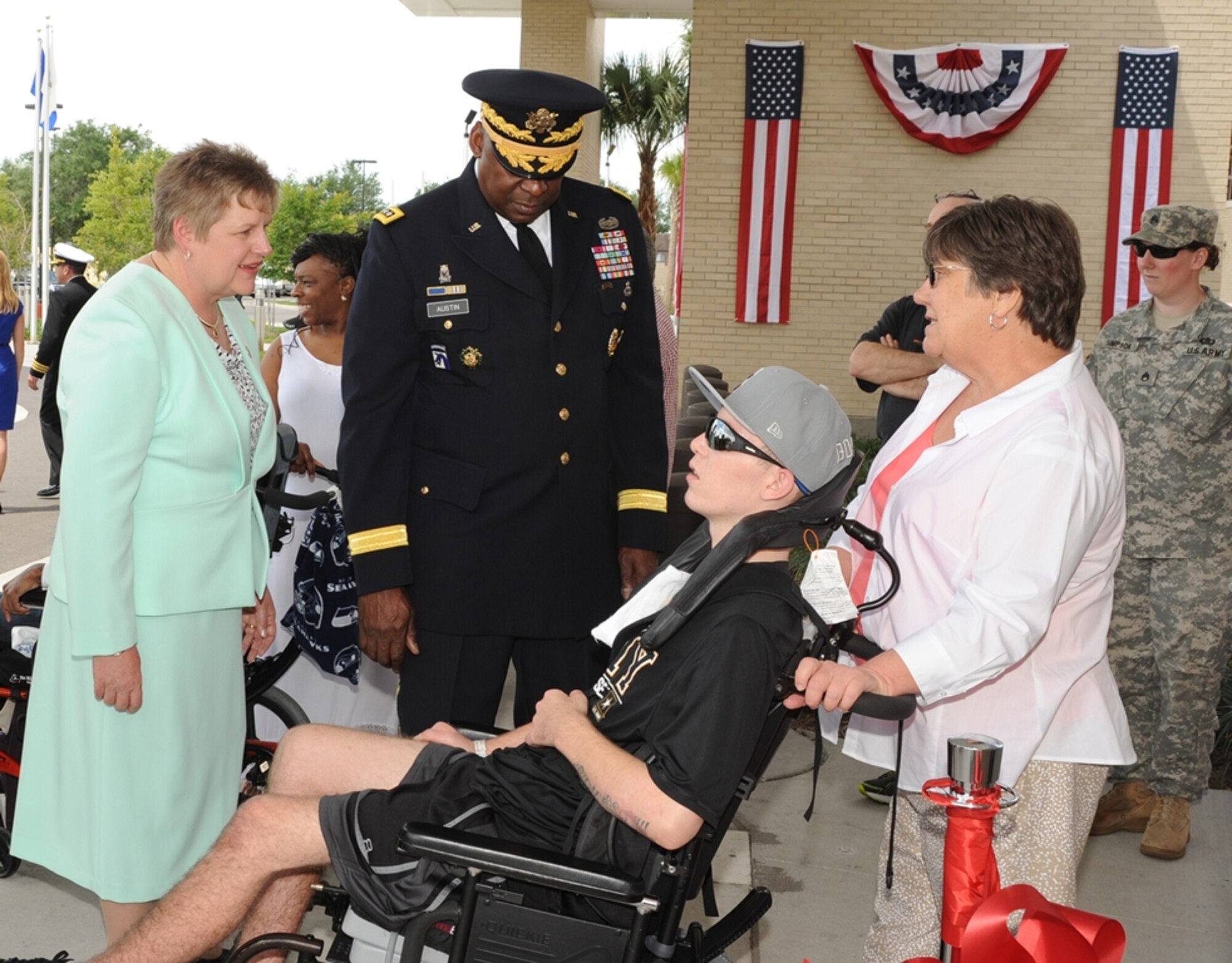 Gen. Lloyd J. Austin III, commander of U.S. Central Command,  and Kathleen Fogarty, James A. Haley Veterans’ Hospital director, (left), greet Army veteran Trae Hines and his grandmother Judy Brewster during the ribbon cutting ceremony to the new Polytrauma and Rehabilitation Center, Apr. 12, 2014.  (U.S. Air Force photo/ Staff Sgt. Liliana Moreno)