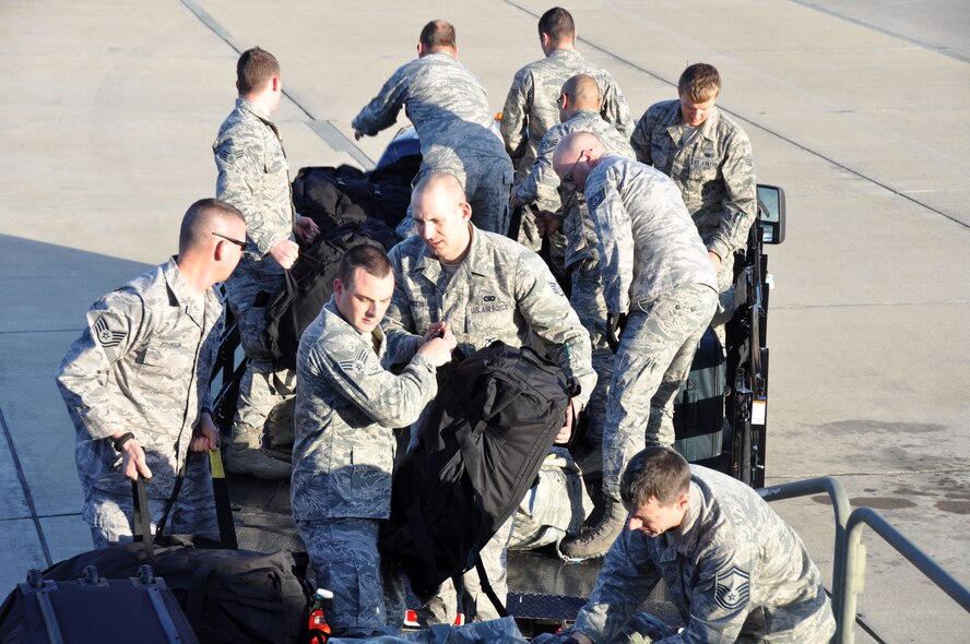 927 SFS members unload their baggage after arriving at MacDill AFB April 16. The 27 member team fulfilled their two week annual tour requirement at RAF Mildenhall, England. (U.S. Air Force photo by Capt. Joe Simms)