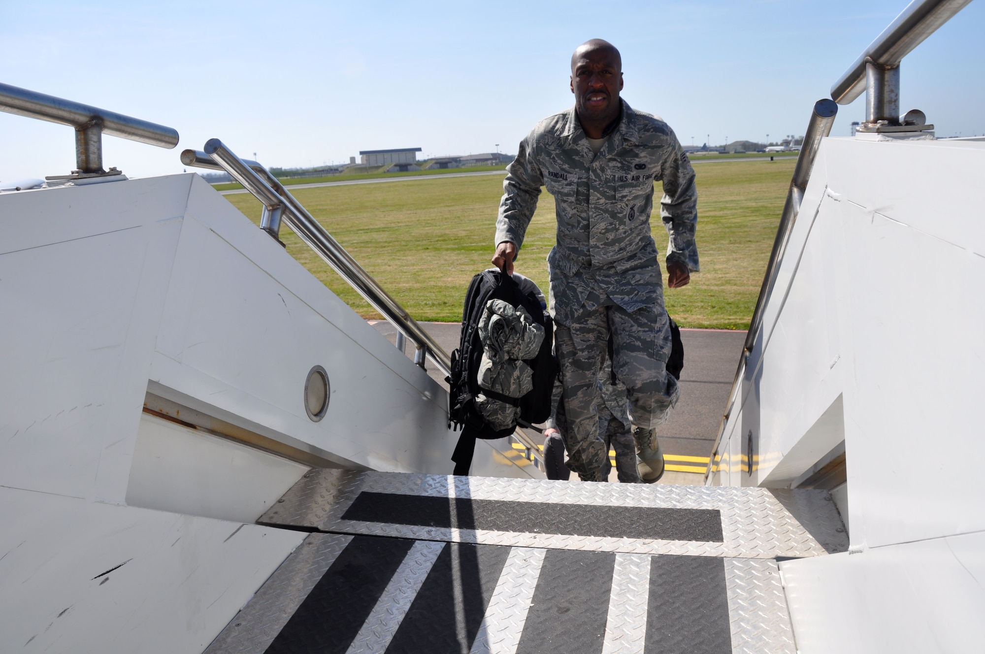 SrA Reginald Randall ascends the stairs of a KC-135 prior to departing RAF Mildenhall England. SrA Randall and 26 other members of the 927 SFS returned home April 16 after a two week training deployment to RAF Mildenhall, England. (U.S. Air Force photo by Capt. Joe Simms)