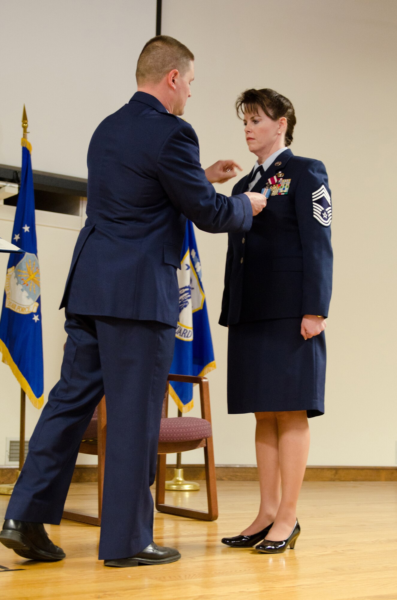 Chief Master Sgt. Lori F. Zinsmeister, the outgoing chief enlisted manager for the Kentucky Air National Guard’s 123rd Airlift Wing, receives a distinguished service medal from Maj. Kevin A. Krauss, commander of the 123rd Force Support Squadron, during her retirement ceremony at the Kentucky Air National Guard Base in Louisville, Ky., March 23, 2014.  Zinsmeister served in the active-duty Air Force and Air National Guard for 26 years. (U.S. Air National Guard photo by Airman Joshua Horton)