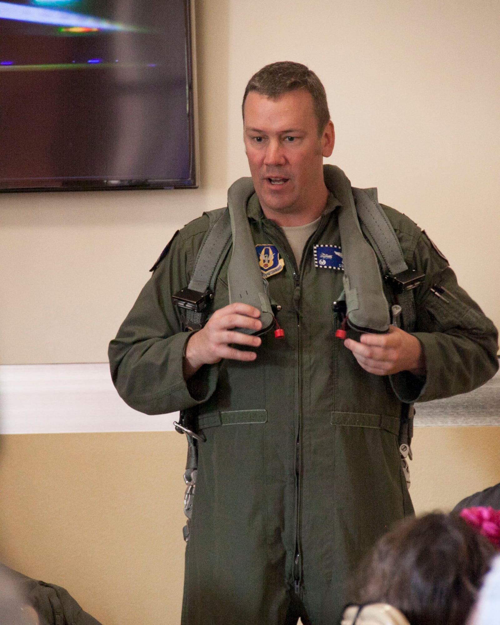Lt. Col. David Sundlov, 93rd Fighter Squadron commander, demonstrates how to wear a Life Preserver Unit, which attaches to a parachute harness, and why it’s important. His demonstration was a favorite among the children in attendance at the Mako Deployed Family Briefing at the Community Activity Center on Homestead Air Reserve Base, Fla., April 12. (U.S. Air Force photo by/Senior Airman Jaimi L. Upthegrove)