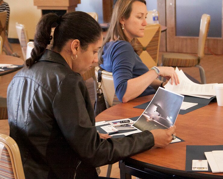All event attendees were given a folder with a plethora of useful information and a photo of a deployed Mako jet during a night take-off at the Mako Deployed Family Briefing at the Community Activity Center on Homestead Air Reserve Base, Fla., April 12. This information will help the families of deployed members know what resources are available to them and how to access those resources. (U.S. Air Force photo by/Senior Airman Jaimi L. Upthegrove)