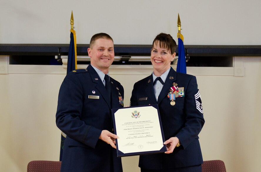 Chief Master Sgt. Lori F. Zinsmeister, the outgoing chief enlisted manager for the Kentucky Air National Guard’s 123rd Airlift Wing, receives her certificate of retirement from Maj. Kevin A. Krauss, commander of the 123rd Force Support Squadron, during a retirement ceremony at the Kentucky Air National Guard Base in Louisville, Ky., March 23, 2014.  Zinsmeister served in the active-duty Air Force and Air National Guard for 26 years. (U.S. Air National Guard photo by Airman Joshua Horton)