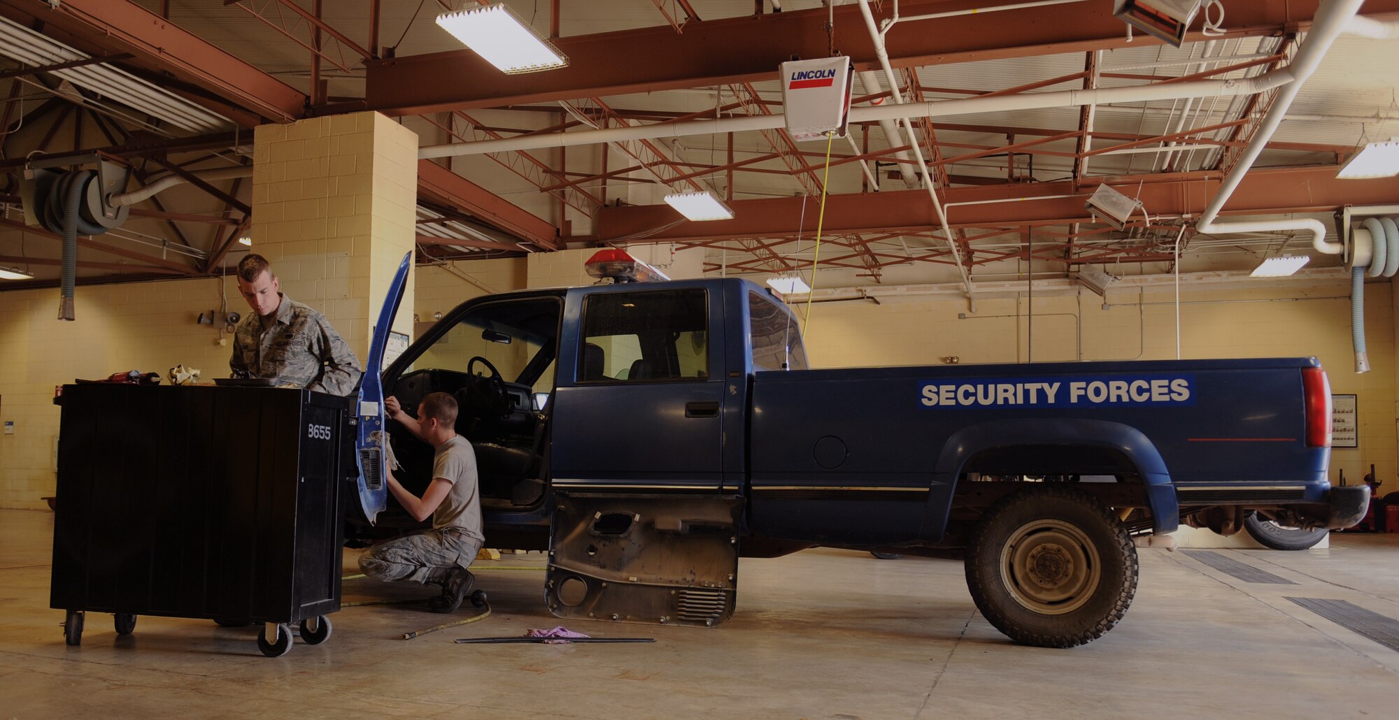 Airmen 1st Class Austin Beam, left, and Zachary Beche, 2nd Logistics Readiness Squadron Vehicle Maintenance Allied Trades section, repair a vehicle on Barksdale Air Force Base, La., April 16, 2014. The allied trade section's main responsibilities include tire repair and replacement and body work for Barksdale's fleet of vehicles ranging from fire trucks, maintenance and government owned vehicles. (U.S. Air Force photo/Senior Airman Benjamin Gonsier)