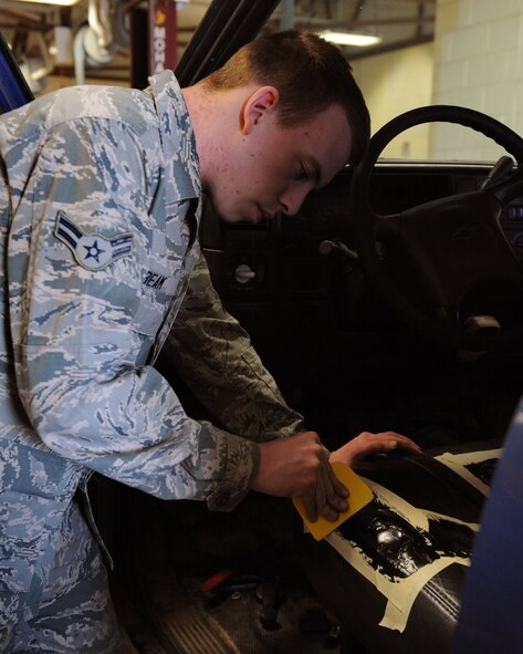 Airman 1st Class Austin Beam, 2nd Logistics Readiness Squadron Vehicle Maintenance Allied Trades section, spreads liquid rubber on a car seat on Barksdale Air Force Base, La., April 16, 2014. To patch tears on rubbery material, a liquid rubber is spread on the tear and once it dries, should resemble the material before it tore. (U.S. Air Force photo/Senior Airman Benjamin Gonsier)