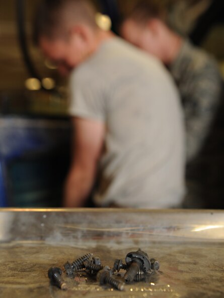 Bolts are set on a magnetic plate as 2nd Logistics Readiness Squadron Vehicle Maintenance Airmen repair a truck on Barksdale Air Force Base, La., April 16, 2014. The magnetic plate ensures nuts, bolts, screws and other vehicle parts aren?t lost during maintenance procedures. (U.S. Air Force photo/Senior Airman Benjamin Gonsier)