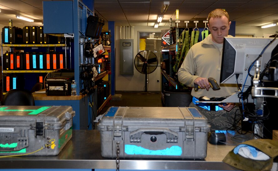 Staff Sgt. Cristopher Weinberg, 20th Aircraft Maintenance Unit Support consolidated tool-kit custodian, scans an item to check out to an Airman on Barksdale Air Force Base, La., April 15, 2014. From crew chiefs to weapons loaders and hydraulics to electronic warfare technicians, the Airmen who form the 20th Aircraft Maintenance Unit Support section come from several Air Force Specialty Codes who work on the flightline. The Airmen rotate periodically to gain a different perspective maintaining the support equipment rather than just working with it to perform maintenance on the B-52H Stratofortress. (U.S. Air Force photo/Staff Sgt. Amber Corcoran)