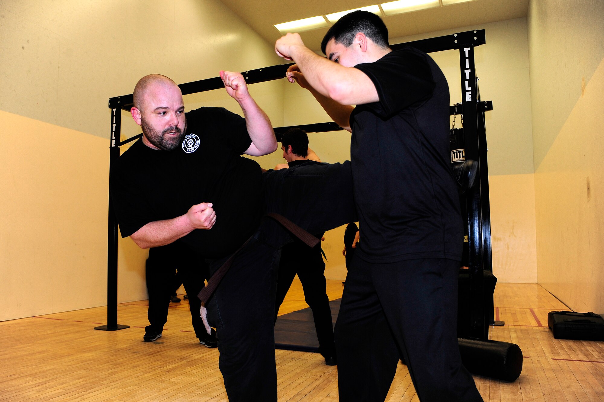 Jack Waid, 354th Fighter Wing historian, performs a kicking drill with 1st Lt. Edward Ramirez, 354th FW sexual assault response coordinator, during a Krav Maga class at the fitness center April 8, 2014, Eielson Air Force Base, Alaska. Along with Krav Maga, Waid has nearly 15 years of experience in various other martial arts. (U.S. Air Force photo by Senior Airman Zachary Perras/Released)