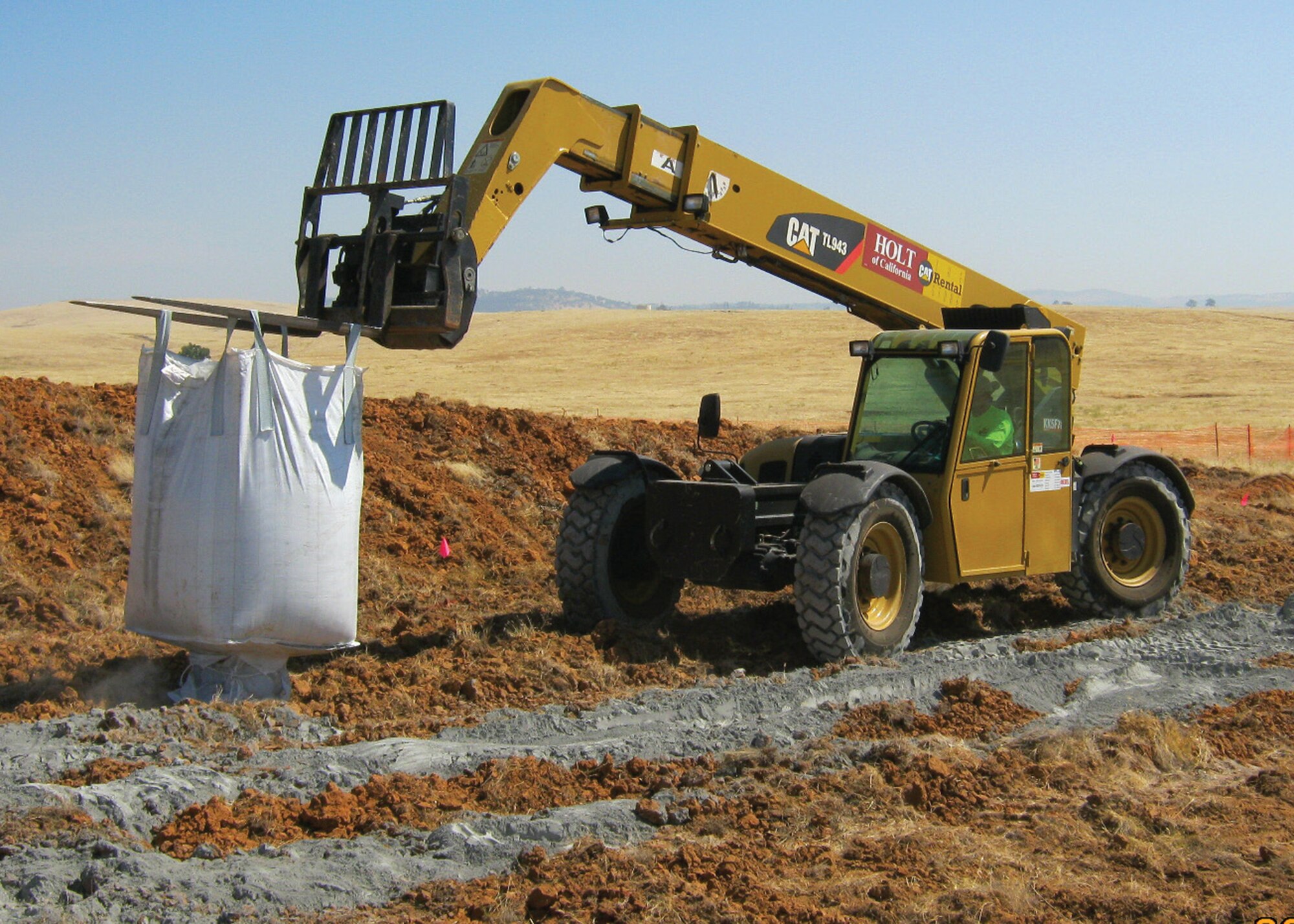 A forklift carries a bag of stabilizer to combat lead-contaminated soil at one of seven closed small arms ranges prior to tilling and excavation at Beale Air Force Base, Calif. This process is a part of the Military Munitions Response Program, which excavated more than 17,000 tons of contaminated top soil as part of the Interim Removal Action. (Courtesy photo)