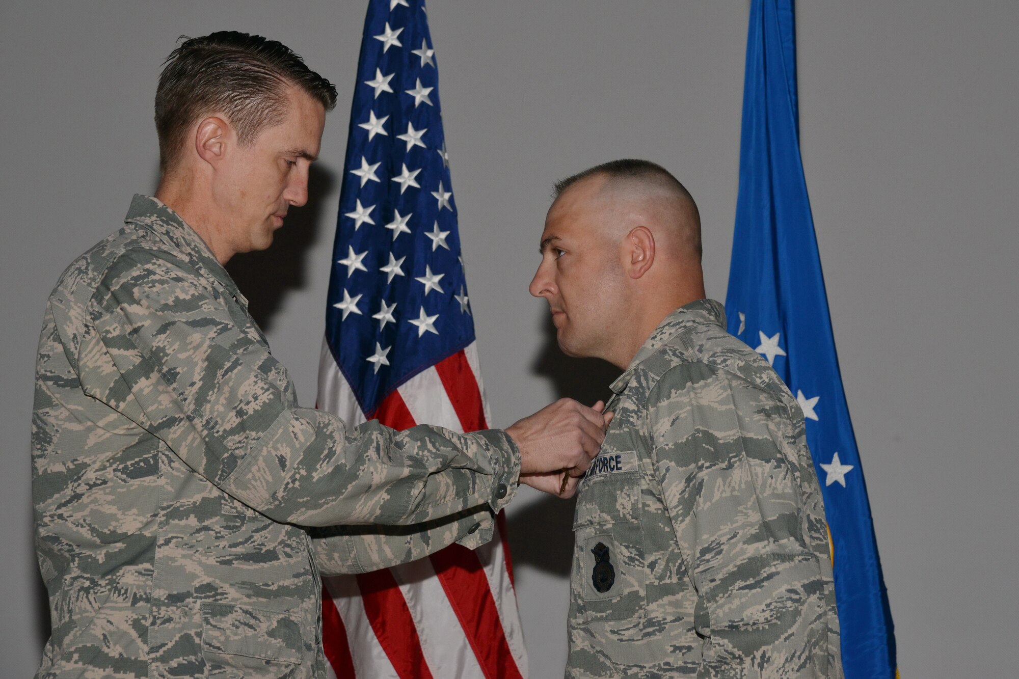 Col. Tom Miller, 377th Air Base Wing commander, pins the Bronze Star Medal on Capt. George Hern (right), 377th Weapons Systems Security Squadron operations officer. Hern received the medal at a ceremony April 16 for counterinsurgency efforts while deployed to Bagram Air Field, Afghanistan, December 2012 to June 2013.(Photo by Ken Moore)